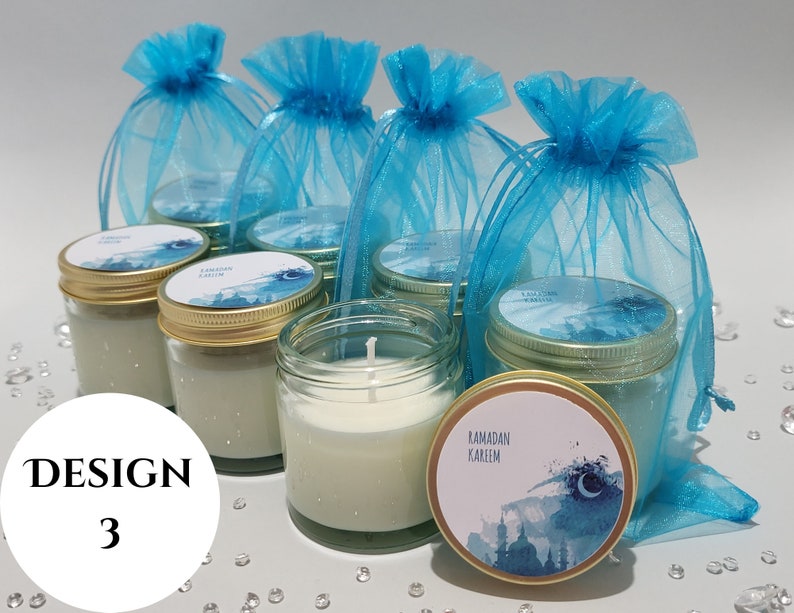May include: Six teal blue organza bags filled with small glass jars with white candles. The jars have gold lids and a blue and white watercolor design with the text "Ramadan Kareem".