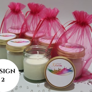 May include: Set of six small glass jars with white candles and gold lids. The jars are decorated with colorful labels that say "Ramadan Kareem". The jars are packaged in pink organza bags.