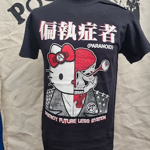 May include: Black t-shirt with a graphic of a Hello Kitty character with a skull and brain on the right side of its face. The graphic also includes the text "Paranoid" and "Destroy Future Less System".