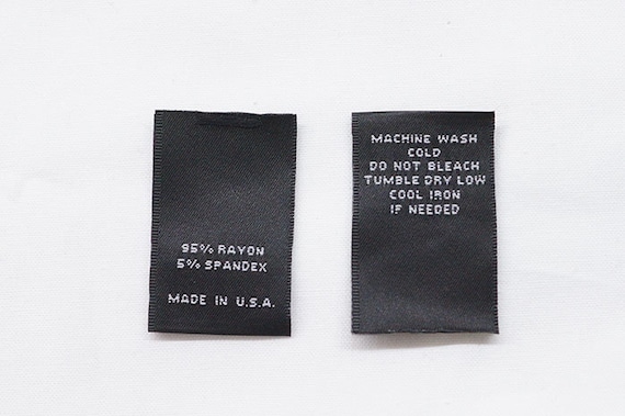 Étiquettes tissées d'entretien pour vêtements Noir avec texte blanc Pliage  central 100 pièces 1 L x 1,5 H plié -  France