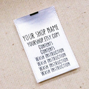 May include: White satin label with black text. The text reads "YOUR SHOP NAME YOURSHOP.ETSY.COM CONTENTS CONTENTS WASH INSTRUCTION WASH INSTRUCTION WASH INSTRUCTION WASH INSTRUCTION"