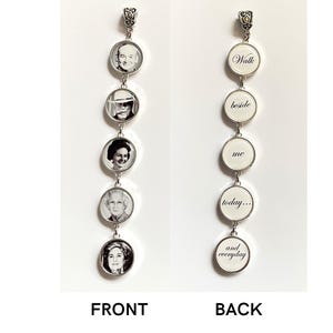 May include: A vertical silver-toned pendant featuring five circular frames. The front displays five distinct black and white portrait photographs. The back displays the text Walk, beside, me, today, and everyday in a black cursive font on white.