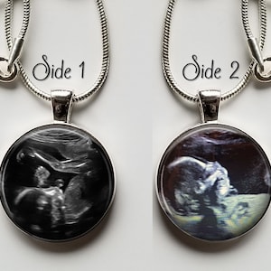 May include: Two silver necklaces with round pendants featuring black and white ultrasound images of a baby. The pendants are labeled "Side 1" and "Side 2".