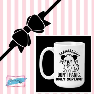 May include: White ceramic mug with a black cartoon illustration of a small animal with the text "AAAAAHHH! DON'T PANIC. ONLY SCREAM!"