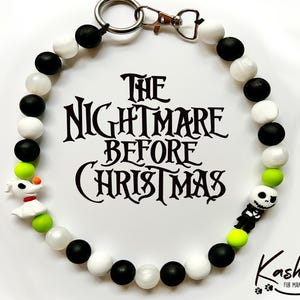 May include: A beaded dog collar featuring black, white, and lime green beads. The collar includes a charm of Zero and Jack Skellington. The text "The Nightmare Before Christmas" is displayed in the center.