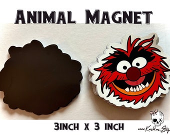 May include: A 3 inch by 3 inch Animal Magnet featuring a red, orange, and black cartoon character with a toothy grin. The magnet is on a white background.