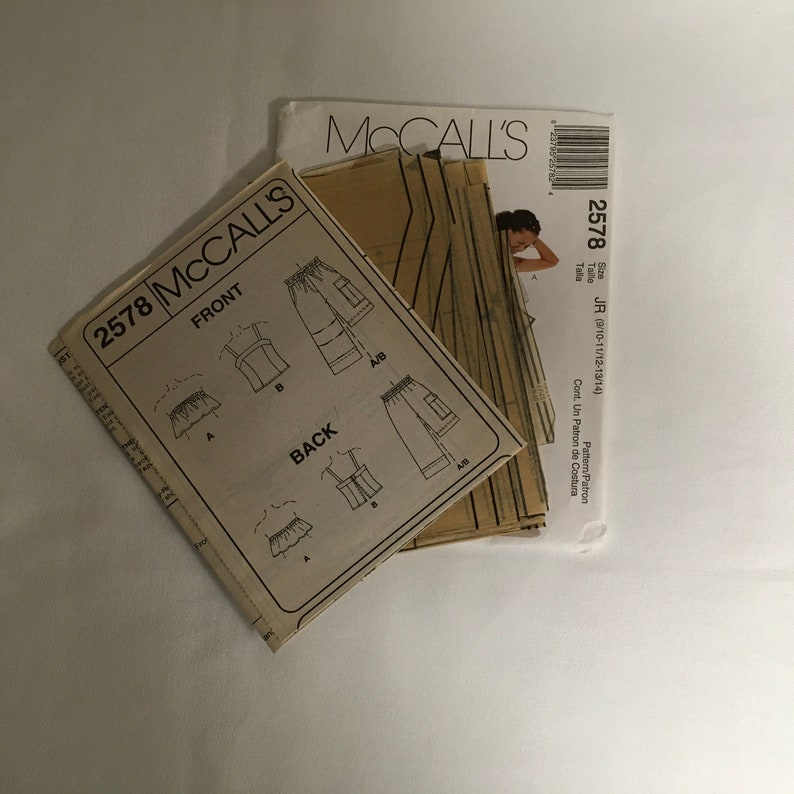 May include: A sewing pattern for a top and pants. The pattern is for sizes 9/10-11/12-13/14. The pattern is from McCall's and the pattern number is 2578.