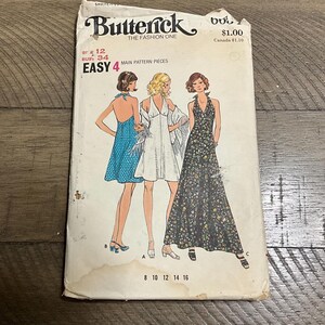 May include: Vintage Butterick sewing pattern featuring illustrations of three dresses. The pattern includes sizes 8, 10, 12, 14, and 16, with a bust size of 34 inches. The cover is off-white with the text "Butterick THE FASHION ONE".