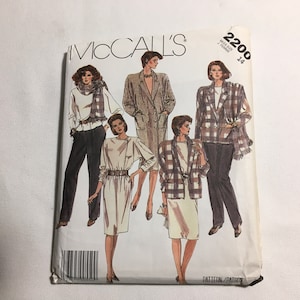 May include: A vintage McCall's sewing pattern with illustrations of women's fashion designs. The cover shows various outfits, including blazers, dresses, and trouser suits. The pattern number is 2200, and the size is 14.