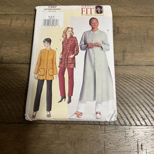 May include: A sewing pattern envelope labeled 7397 Today's Fit by Sandra Betzina. The front displays illustrations of three different jacket and tunic styles in yellow, red plaid, and light gray, paired with dark and light trousers on a white background.