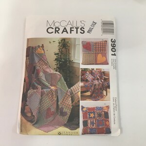 May include: McCall's Crafts sewing pattern number 3901 for a quilt and pillows. The pattern includes instructions for making a patchwork quilt with a heart design and two pillows with different patchwork designs. The pattern is for a final sale.
