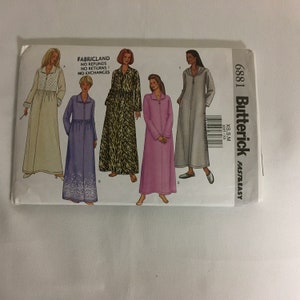 May include: Butterick sewing pattern 6881 for robes and dresses. The pattern features multiple designs, including a long-sleeved robe with a hood and a button-down dress. The pattern includes the text "FABRICLAND NO REFUNDS NO RETURNS NO EXCHANGES".