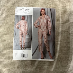 May include: A sewing pattern for a jumpsuit with a floral print. The pattern is for sizes 14-16-18-20-22. The pattern is by Rachel Comey and is a Vogue pattern.
