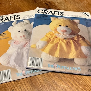 May include: A set of three ceramic mugs with a speckled, matte finish. The mugs are in shades of cream, light gray, and dark gray. Each mug has a simple, minimalist design, perfect for coffee or tea.