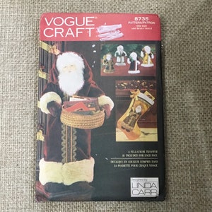May include: A vintage Vogue Craft sewing pattern for making a Santa Claus and a Christmas stocking. The pattern is number 8735 and includes a full-color transfer for each face. The pattern is designed by Linda Carr.