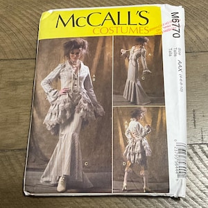 May include: McCall's Costumes sewing pattern M6770 for a women's costume. The pattern includes instructions for a long skirt with a ruffled hem, a jacket with a ruffled collar, and a vest. The pattern is for sizes AAX (4-6-8-10).