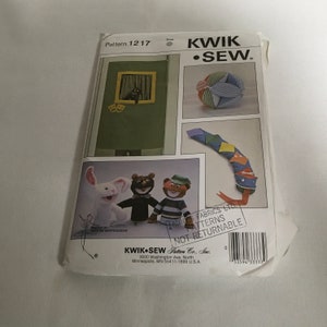 May include: A sewing pattern for making a puppet show, a ball, and a snake. The pattern is from Kwik-Sew Pattern Co., Inc. and is number 1217. The pattern is not returnable.