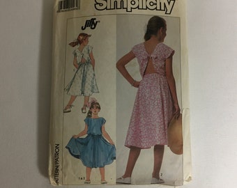 Simplicity 7977 Sewing Pattern Girl‘s Dress Cap Sleeves Side Seam  Pockets Very Full Skirt Stitched To Bodice Back Tie Closures Size 7 8 10