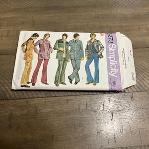 May include: A vintage Simplicity sewing pattern for men's clothing. The pattern number is 6273 and the price is 50p. The pattern features four different styles of men's clothing, including a jacket and pants, a shirt and pants, a jacket and pants, and a shirt and pants.