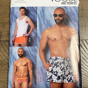 May include: Vogue Patterns V1897 sewing pattern envelope for sizes XLG-XXL-XXXL. The front displays three variations of shorts and swimwear, including solid orange shorts with white trim, floral print swim trunks, and patterned swim briefs.