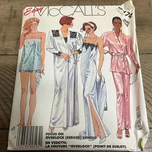 May include: A vintage McCall's sewing pattern featuring illustrations of women's sleepwear. The pattern includes designs for a slip, robe, and pajama set. The cover has text that reads "Focus on Overlock (Serger) Sewing" and "Small Petite".