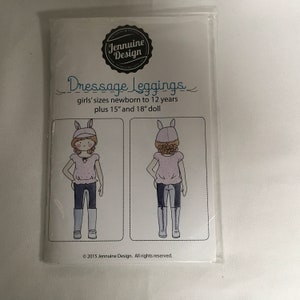 May include: A sewing pattern for dressage leggings for girls, featuring two illustrations of dolls wearing the leggings. The pattern is for sizes newborn to 12 years, plus 15" and 18" dolls. The text on the pattern reads "Dressage Leggings, girls' sizes newborn to 12 years plus 15" and 18" doll, © 2015 Jennuine Design. All rights reserved."
