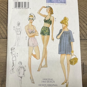 May include: A Vogue Patterns sewing pattern envelope for a 1960 design, featuring illustrations of two-piece swimsuits and a cover-up. The text includes Vogue Vintage Model, V9255/E5, and Original 1960 Design. The envelope displays size E5 (14-16-18-20-22).