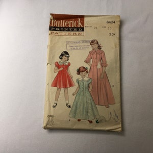 May include: Vintage sewing pattern for a girl's dress. The pattern is from Butterick and is for size 10, with a 28 inch bust. The pattern is for a dress with a collar and a full skirt. The pattern is 35 cents.