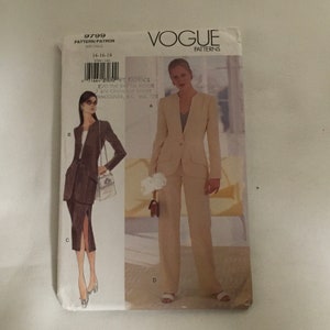 May include: Vogue Patterns sewing pattern number 9799 for sizes 14-16-18. The pattern includes instructions for making a suit with a jacket and pants. The model is wearing a beige suit with a white blouse. The pattern is printed on white paper with black text.