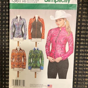 May include: Simplicity sewing pattern 1361 for women's jackets. The pattern features various jacket designs, including a pink jacket with a decorative design, and other jackets with different patterns and colors. The pattern includes sizing information.