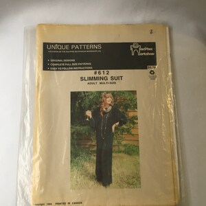 May include: A sewing pattern for a slimming suit, featuring a woman wearing a black jumpsuit. The pattern is labeled "#612 Slimming Suit" and is for adult multi-sizes. The pattern is from Unique Patterns, a division of the MacPhee Outerwear Workshop Ltd.