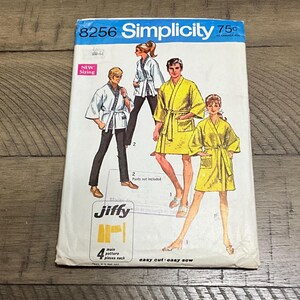 May include: Simplicity sewing pattern number 8256 for a robe. The pattern includes instructions for making a robe with a sash. The pattern is labeled "easy cut - easy sew" and "Jiffy".