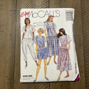 May include: A sewing pattern for four different styles of dresses. The pattern is for petite sizes and includes instructions for adjustable straps. The pattern is from McCall's and the pattern number is 405.