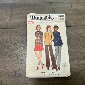 May include: Vintage sewing pattern for a double-breasted coat with a plaid pattern, a brown coat with a double-breasted closure, and a navy blue coat with a double-breasted closure. The pattern is for sizes 7-16 and is from the brand Butterick, The Fashion One, Judy Camary. The pattern number is 6761 and the price is £1.00.