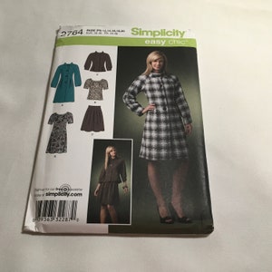 May include: Simplicity sewing pattern number 2764, easy chic, for sizes 12, 14, 16, 18, and 20. The pattern includes instructions for making a dress, a jacket, a skirt, and a blouse. The pattern is shown on a white background with a model wearing a black and white plaid jacket and skirt.