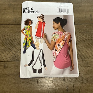 May include: A sewing pattern for a women's top with a back tie. The pattern is from Butterick and has the number B6216 on it. The pattern includes four different styles of tops, all with a unique back design.
