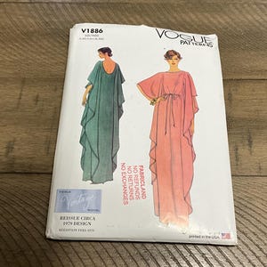 May include: A Vogue Patterns sewing pattern envelope V1886 featuring illustrations of a floor-length kaftan dress in teal and coral. The text includes Vogue Patterns, V1886, Reissue Circa 1979 Design, and Fabricland No Refunds No Exchanges.