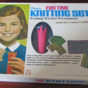 May include: A vintage Hasbro Fun Time Knitting Set box with a girl knitting on the front. The box features a pink knitting loom, yarn, and instructions in French. The box is white with blue and red accents. The text on the box reads "Fun Time Knitting Set" and "It's easy! It's fun! It's creative!"  The box is for ages 5-12.