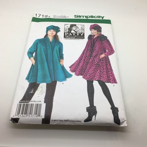 May include: A Simplicity 1719A sewing pattern envelope by Patty Reed Designs featuring illustrations of two flared coats and matching hats. One coat is solid teal, and the other is a pink and black leopard print. Includes a barcode and text.