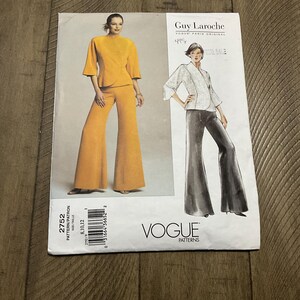 May include: A vintage Vogue sewing pattern for a trouser suit. The pattern is for sizes 8, 10, and 12. The pattern is by Guy Laroche and is called "Vogue Paris Original". The pattern number is 2752.