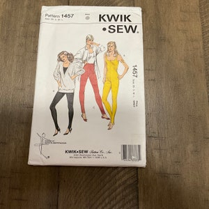 May include: A Kwik Sew pattern packet, model 1457, featuring illustrations of women's clothing designs. The packet includes a variety of styles, including a jumpsuit, pants, and a sweater. The size range is XS-S-M-L.