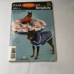 May include: Simplicity sewing pattern number 3664, bin 7, for making dog clothes. The pattern includes instructions for making a red and blue dog coat. The pattern is for all sizes. The image shows two dogs wearing the coats.
