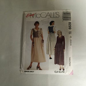 May include: A sewing pattern for a dress with a plaid design. The pattern is for sizes 10, 12, and 14. The pattern is from McCall's Easy and is called "Cut-to-Fit".