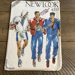May include: A New Look 6353 sewing pattern envelope featuring illustrations of three athletic outfits. The designs include a white hooded jacket with shorts, a red jacket with blue track pants, and a blue track jacket with matching blue track pants.