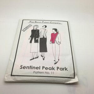 May include: A sewing pattern for a women's sweater, jacket, and pants. The pattern is called "Sentinel Peak Park" and is pattern number 11. The pattern is from Park Bench Pattern Company.