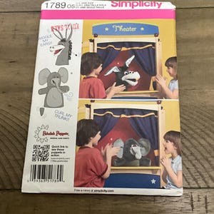 May include: Simplicity pattern 1789 OS for making puppets. The package shows a donkey and an elephant puppet in a theater setting. The text on the package says "Wiggle my ears!!" and "Curl my trunk!!".