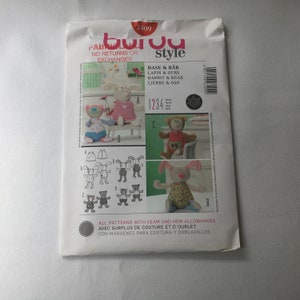 May include: A sewing pattern for making stuffed animals. The pattern includes instructions for making a bunny, a bear, and a dog. The pattern is printed on a white background with black and white illustrations. The pattern is titled "Fabborou Style" and has the number 7409 printed on it.