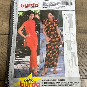 May include: A Burda International sewing pattern envelope, number 2954, featuring illustrations and photographs of a dress, top, and trousers. The package displays sizing options 34, 36, 38, 40 and 8, 10, 12, 14, with text indicating average difficulty.