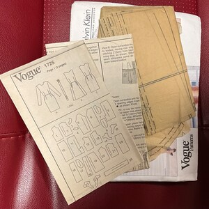 May include: A vintage Vogue sewing pattern for a dress, with instructions and diagrams for cutting and assembling the garment. The pattern is for size 1725 and includes a basic dress and a bodice.