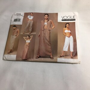 May include: Vogue Wardrobe sewing pattern number 2426 for sizes 6-16. The pattern includes four different styles of tops and pants. The pattern is printed on white paper with black text and images.